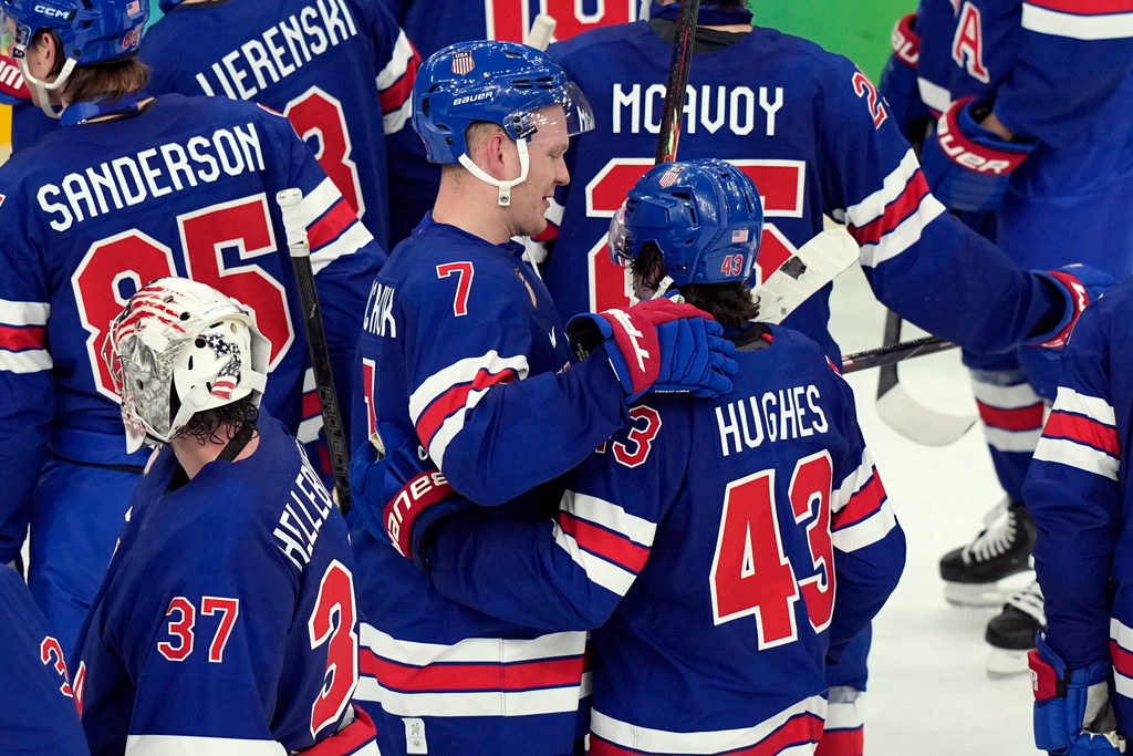 United States' Quinn Hughes (43) celebrates with Brady Tkachuk (7) after Hughes scored the winning goal in overtime to beat Sweden in a men's ice hockey quarterfinal game at the 2026 Winter Olympics, in Milan, Italy, Wednesday, Feb. 18, 2026. (AP Photo/Hassan Ammar)