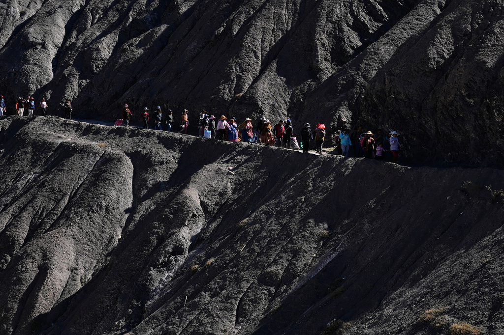 People walk towards a impromptu market in Avircato, Bolivia, set up by producers who are unable to transport their vegetables into the city because of protest blockades, Thursday, June 4, 2026. (AP Photo/Juan Karita)