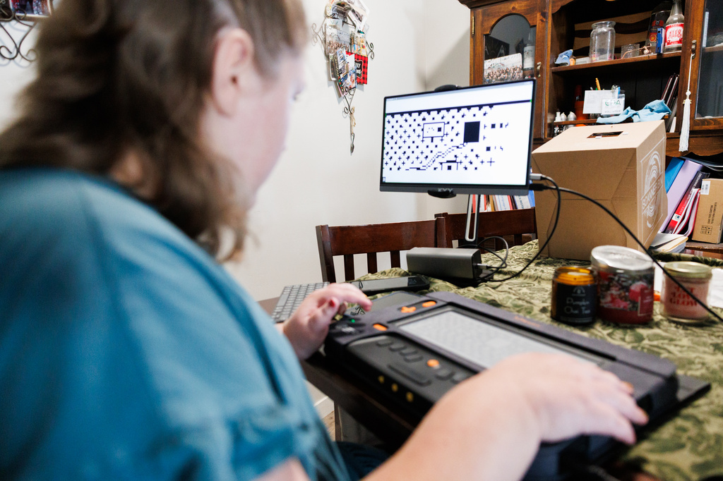 Isabelle Harris uses her braille display on Thursday, June 18, 2026, in Grand Junction, Colo. (AP Photo/Jacob Spetzler)