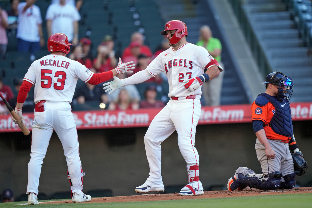 Los Angeles Angels Mike Trout (27) is greeted at home plate by Wade Meckler (53) after Trout's solo home run against the Houston Astros during the first inning of a baseball game Wednesday, June 10, 2026, in Anaheim, Calif. (AP Photo/Scott Strazzante)