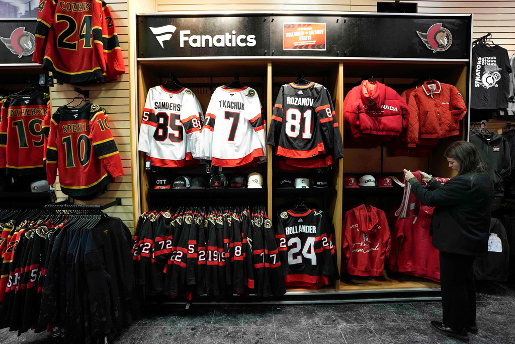 Ottawa Senators jerseys with the names of Hollander and Rozanov, the main characters from the hit Canadian sports romance television show Heated Rivalry, hang in the Senators' official store beside the jerseys of Senators players, including captain Brady Tkachuk, before an NHL hockey game against the New Jersey Devils in Ottawa, Ontario, Jan. 31, 2026. (Justin Tang/The Canadian Press via AP, File)