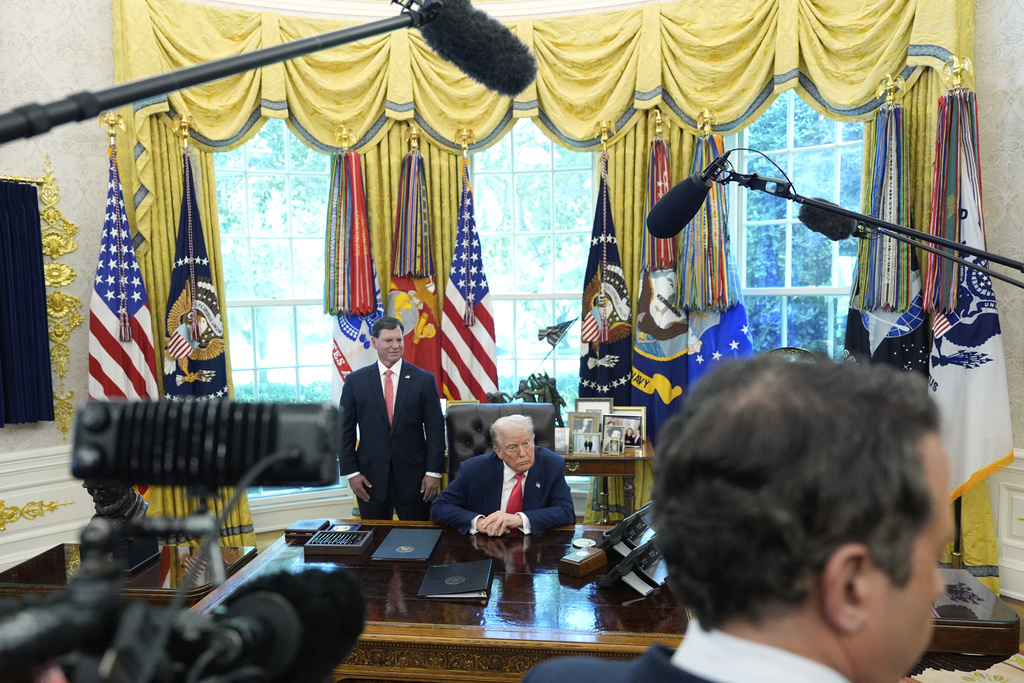 President Donald Trump, center, and Social Security Commissioner Frank Bisignano, left, attend an event in the Oval Office to mark the 90th anniversary of the Social Security Act, Thursday, Aug. 14, 2025, in Washington. (AP Photo/Alex Brandon)