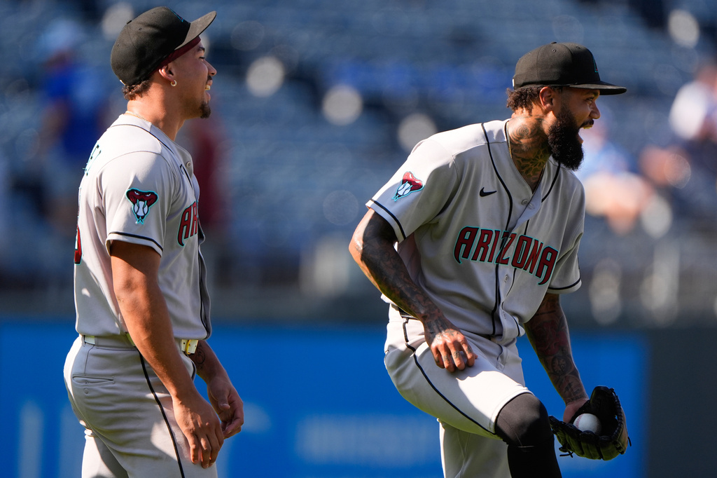 Arizona Diamondbacks' Justin Martinez, left, and Dennis Santana celebrate after their baseball game against the Kansas City Royals, Monday, Sept. 7, 2026, in Kansas City, Mo. (AP Photo/Charlie Riedel)