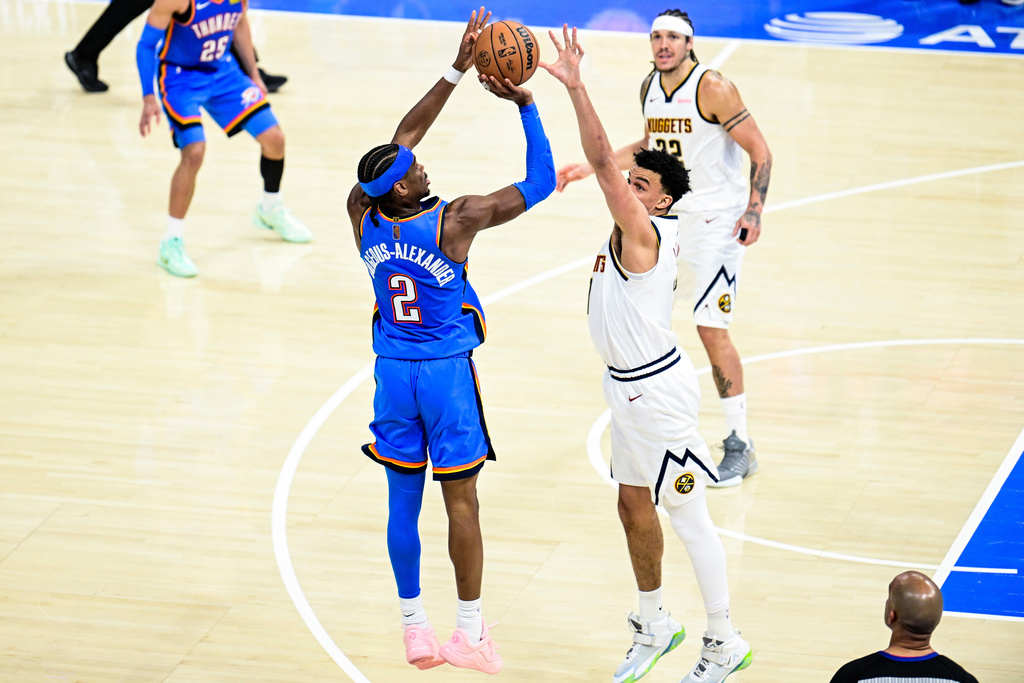Oklahoma City Thunder guard Shai Gilgeous-Alexander (2) shoots against Denver Nuggets forward Spencer Jones (21) during the second half of an NBA basketball game Monday, March 9, 2026, in Oklahoma City. (AP Photo/Gerald Leong)