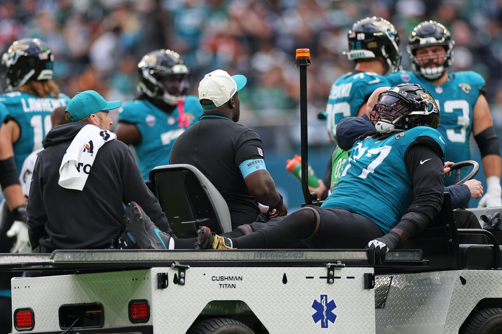 Jacksonville Jaguars offensive tackle Anton Harrison (77) is driven from the field after an injury during an NFL football game against Philadelphia Eagles in London, Sunday, Oct. 11, 2026. (AP Photo/Ian Walton)