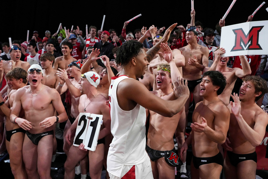 Miami (OH) forward Eian Elmer, center, celebrates with fans following an NCAA college basketball game against UMass, Tuesday, Jan. 27, 2026, in Oxford, Ohio. (AP Photo/Jeff Dean)
