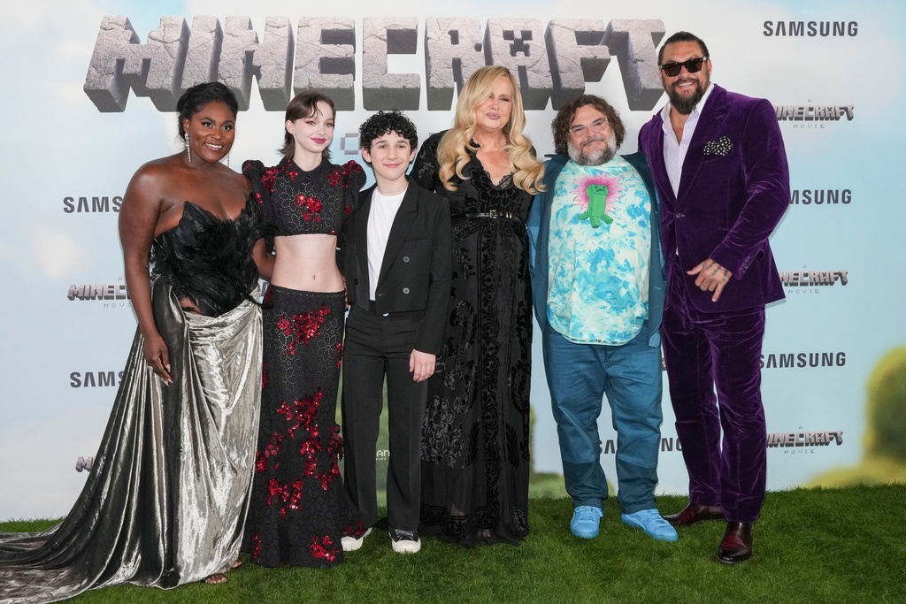 FILE - From left, Danielle Brooks, Emma Myers, Sebastian Hansen, Jennifer Coolidge, Jack Black and Jason Momoa pose for photographers upon arrival at the World premiere of A Minecraft Movie, March 30, 2025, in London. (Photo by Scott A Garfitt/Invision/AP, File)