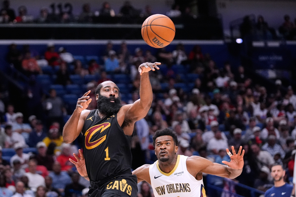 Cleveland Cavaliers guard James Harden (1) passes around New Orleans Pelicans center Yves Missi in the first half of an NBA basketball game, Saturday, March 21, 2026, in New Orleans. (AP Photo/Gerald Herbert)
