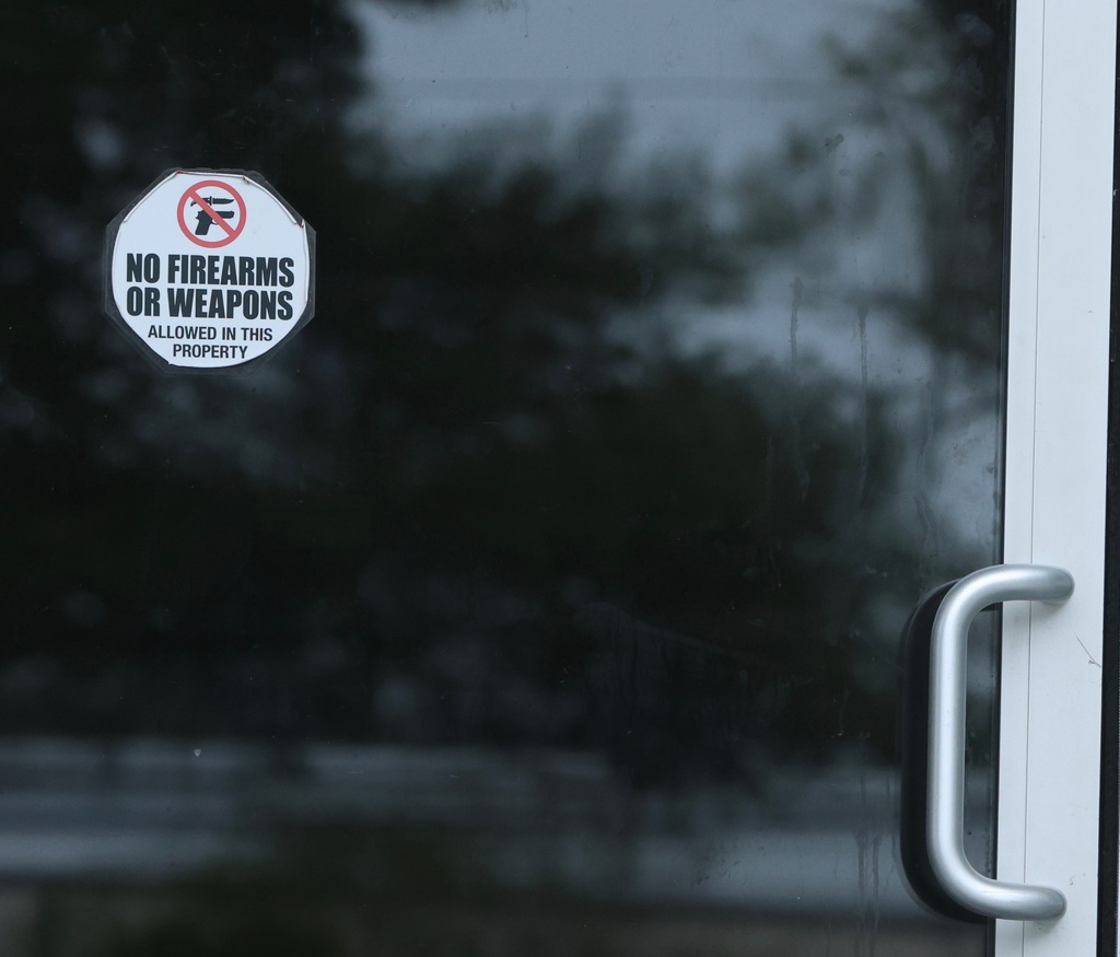 A sticker on the door of Willie's Bar and Grill in St Helena Island, S.C. after a shooting occurred early Sunday, Oct. 12, 2025. (AP Photo/Lewis M. Levine)