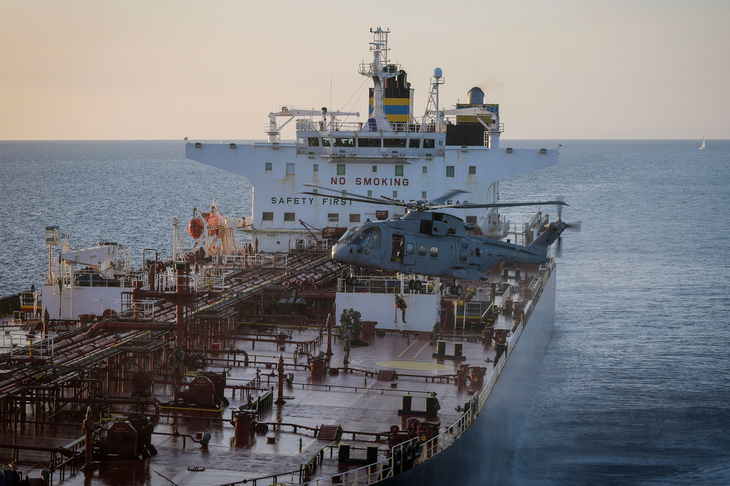 In this photo provided by the Royal Navy, Royal Marine Commandos detain sanctioned tanker, the Smyrtos, in the English Channel, Sunday, June 14, 2026. (LPhot Hutchins/Royal Navy via AP)