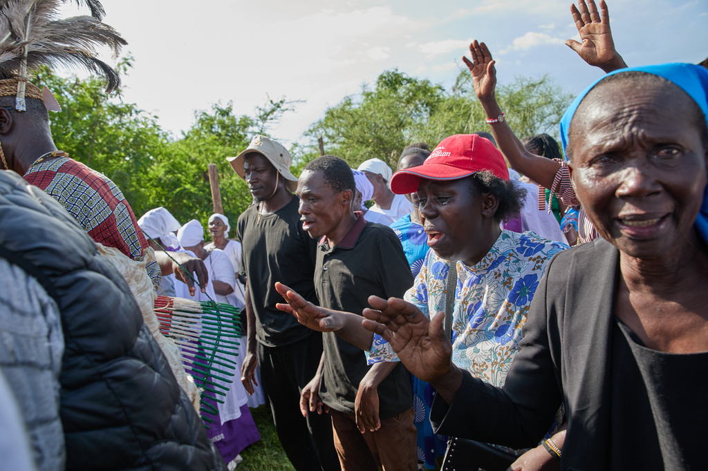 Professional mourners grieve alongside family members and friends of the deceased during a funeral on the outskirts of Kisumu, Kenya, Friday, March 13, 2026. (AP Photo/Asa Wallin)