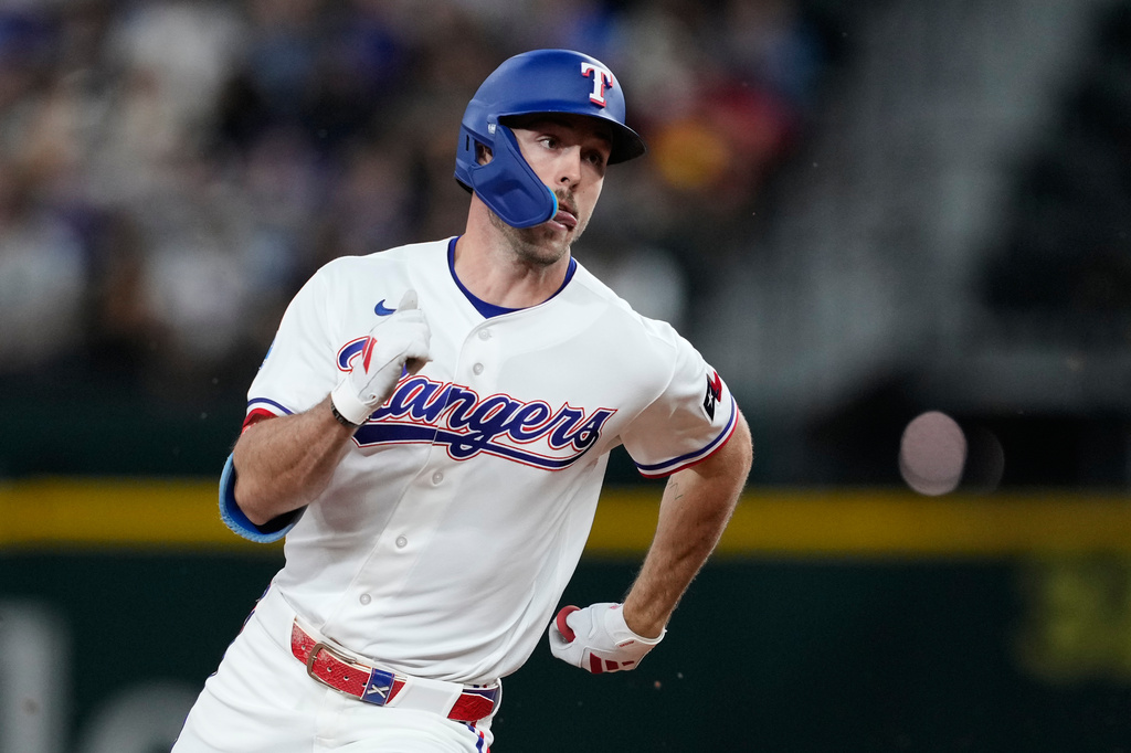 Texas Rangers' Evan Carter rounds the bases on his way home after hitting a two-run inside the park home run in the third inning of a baseball game against the Pittsburgh Pirates Thursday, April 23, 2026, in Arlington, Texas. (AP Photo/Tony Gutierrez)