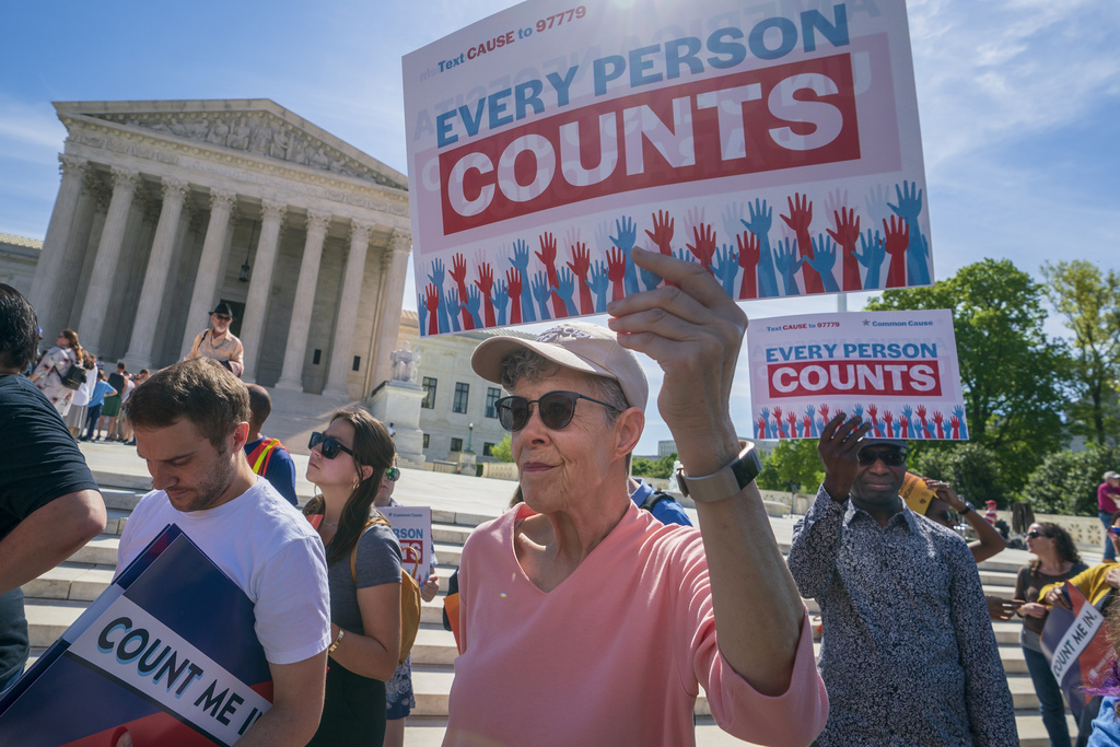 FILE - Immigration activists rally outside the Supreme Court as the justices hear arguments over the Trump administration's plan to ask about citizenship on the 2020 census, in Washington, April 23, 2019. (AP Photo/J. Scott Applewhite, File)