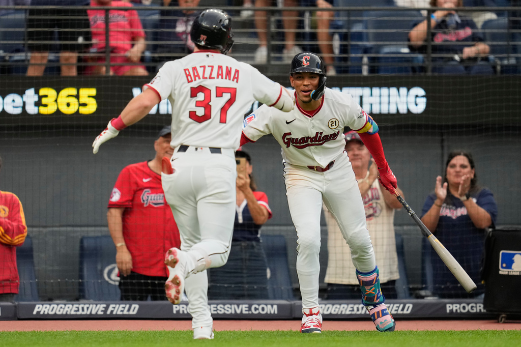 Cleveland Guardians' Travis Bazzana (37) is congratulated by Angel Genao, right, after hitting a home run in the first inning of a baseball game against the Chicago White Sox in Cleveland, Tuesday, Sept. 15, 2026. (AP Photo/Sue Ogrocki)