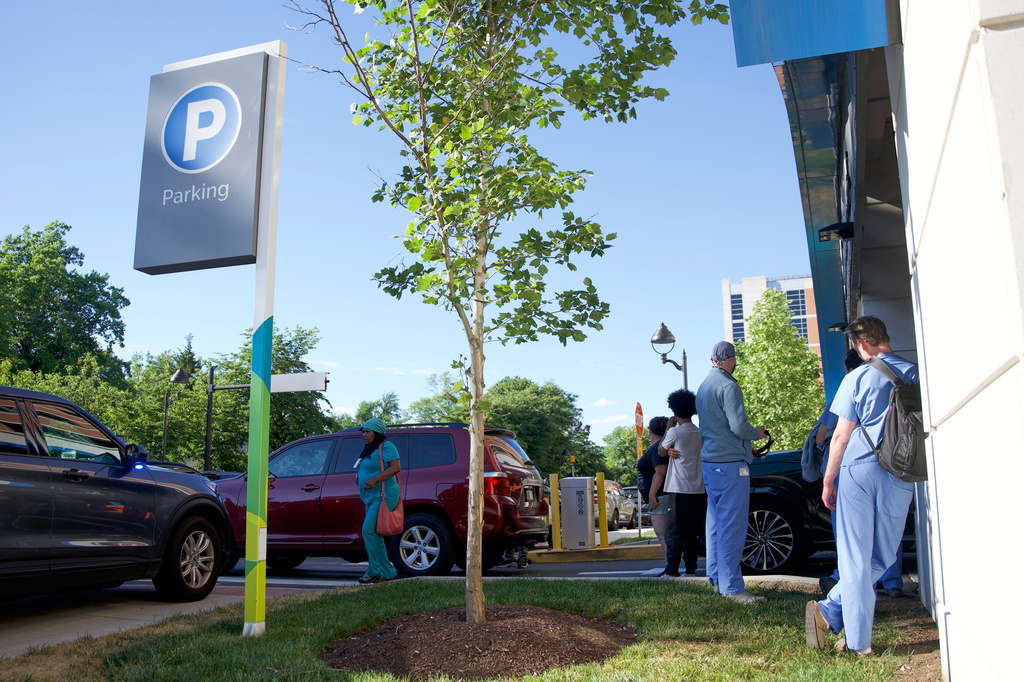 People stand in the perimeter of Wilmington Hospital in the aftermath of a shooting on Tuesday, June 16, 2026, in Wilmington, Del. (AP Photo/Mingson Lau)
