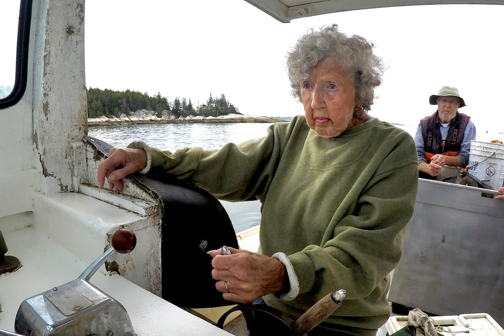 FILE - Virginia Oliver, 101, pilots the boat of her son, Max Oliver, Aug. 31, 2021, off Rockland, Maine. (AP Photo/Robert F. Bukaty, File)