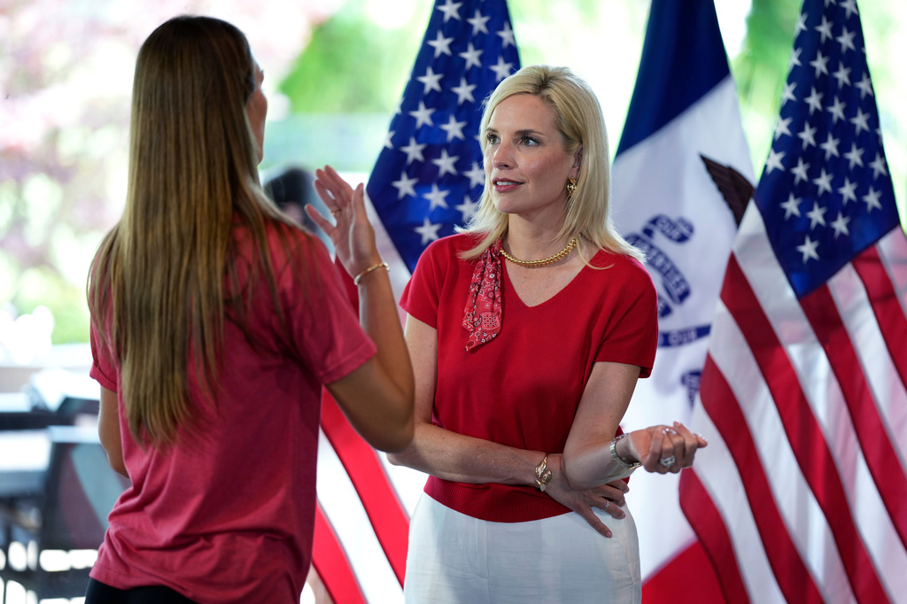 Rep. Ashley Hinson, R-Iowa, talks with an audience member during a campaign rally, Saturday, May 30, 2026, in West Des Moines, Iowa. (AP Photo/Charlie Neibergall)