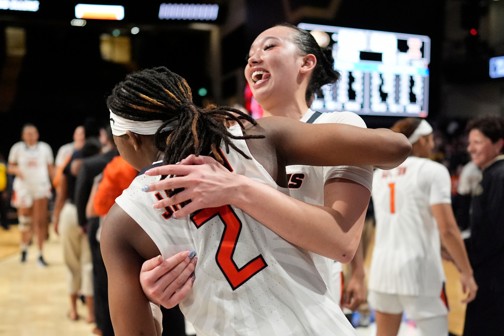 Illinois guard Maddie Webber, right, and Destiny Jackson (2) celebrate after the team's win in the first round of the NCAA college basketball tournament against Colorado, Saturday, March 21, 2026, in Nashville, Tenn. (AP Photo/George Walker IV)