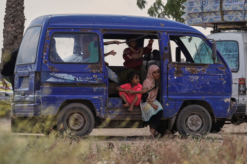 Displaced Yemeni children sit in a vehicle as families gather to receive aid at the Al-Fallahine displacement camp in Dar Saad district, Aden, Yemen, Monday, Oct. 12, 2026. (AP Photo/Abdulnasser Alseddik)
