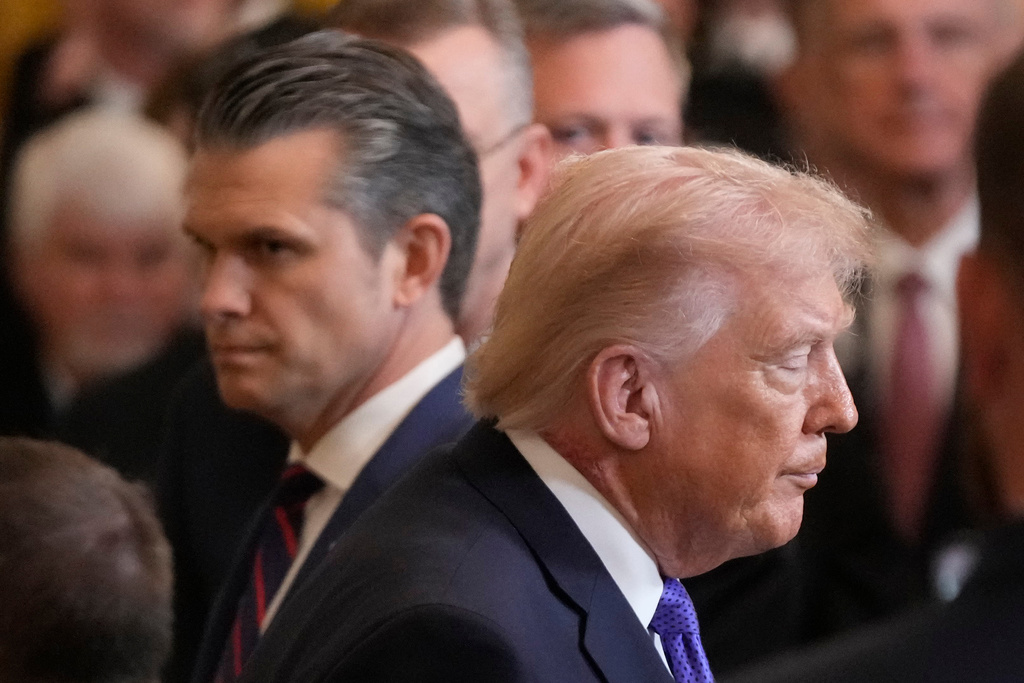 President Donald Trump walks past Defense Secretary Pete Hegseth as he exist the East Room of the White House following the Medal of Honor ceremony, Monday, March 2, 2026, in Washington. (AP Photo/Mark Schiefelbein)