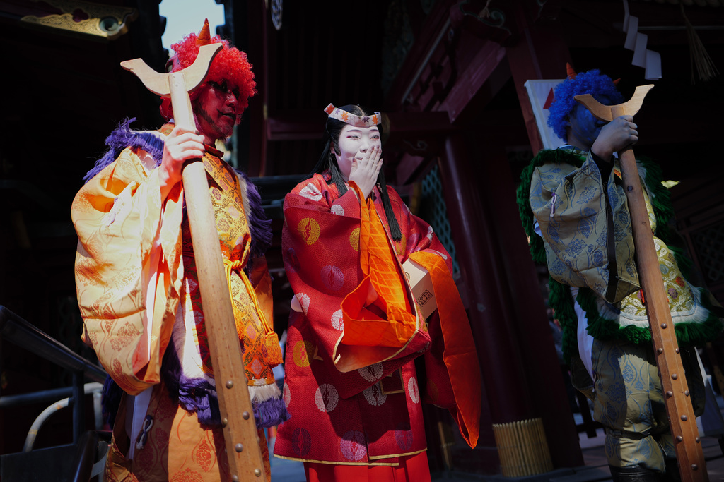Locals dressed as Japanese folklore figures participate in the annual Bean Throwing Festival in Hakone, Japan, Tuesday, Feb. 3, 2026. (AP Photo/Eugene Hoshiko)