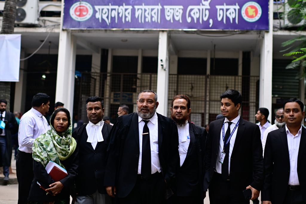 Public Prosecutor Muhammad Tariqul Islam, center, walks out after a hearing at the Dhaka Special Judge's Court in Dhaka, Bangladesh, Monday, Dec. 1, 2025. (AP Photo/Mahmud Hossain Opu)