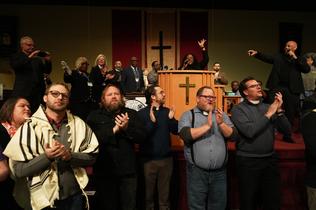 FILE - Faith leaders from across the United States sing together as a sign of support for Haitian migrants fearing the end of their Temporary Protected Status in the U.S., at an event held at St. John Missionary Baptist Church in Springfield, Ohio, on Feb. 2, 2026. (AP Photo/Luis Andres Henao, file)