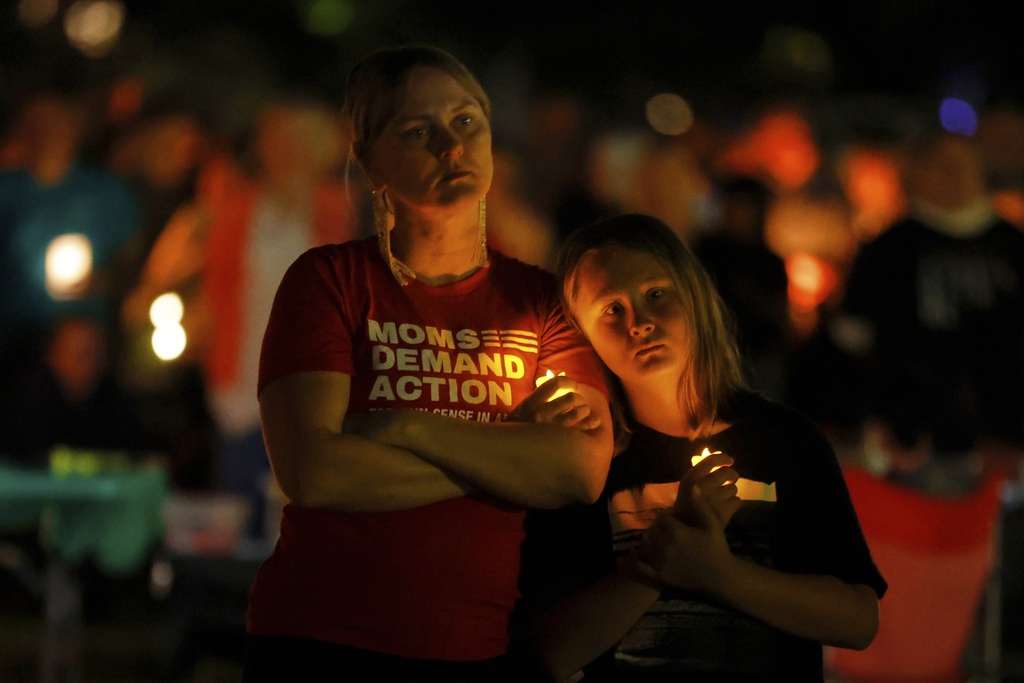 People gather at a vigil at Lynnhurst Park after a shooting at the Annunciation Catholic School Wednesday, Aug. 27, 2025, in Minneapolis. (AP Photo/Bruce Kluckhohn)