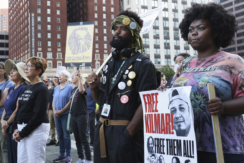People attend a protest rally at the Immigration and Customs Enforcement field office in Baltimore, Monday, Aug. 25, 2025, to support Kilmar Abrego Garcia. (AP Photo/KT Kanazawich)