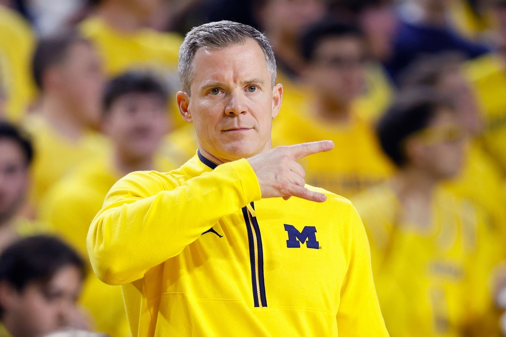 Michigan head coach Dusty May signals to his team during the first half of an NCAA college basketball game against Rutgers, Saturday, Dec. 6, 2025, in Ann Arbor, Mich. (AP Photo/Duane Burleson)