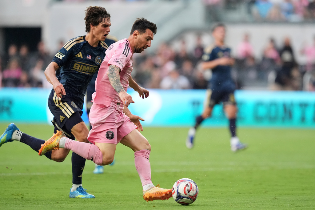 Inter Miami forward Lionel Messi (10) drives downfield under pressure from Philadelphia Union midfielder Ben Bender (16) during the first half of an MLS soccer match, Sunday, May 24, 2026, in Miami. (AP Photo/Rebecca Blackwell)