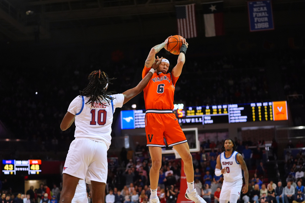 Virginia guard Jacari White (6) grabs the ball against SMU center Jaden Toombs (10) during the second half of an NCAA college basketball game Saturday, Jan. 17, 2026, in Dallas. (AP Photo/LM Otero)