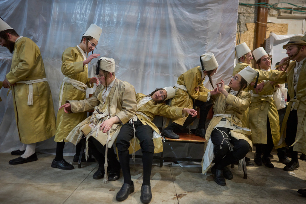 Ultra-Orthodox Jewish men celebrate the festival of Purim in Jerusalem, Wednesday, March 4, 2026. (AP Photo/Ohad Zwigenberg)