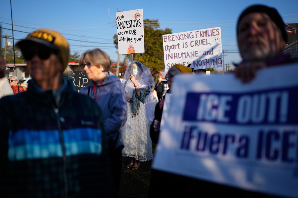 Protesters gather outside an ICE processing facility in the Chicago suburb of Broadview, Ill., Friday, Oct. 31, 2025. (AP Photo/Nam Y. Huh)