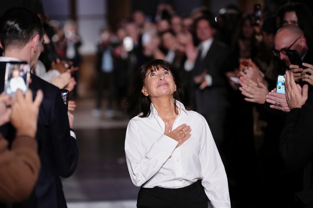 Designer Veronique Nichanian accepts applause after the Hermes Fall/Winter 2026-2027 Men's collection presented in Paris, Saturday, Jan. 24, 2026. (AP Photo/Aurelien Morissard)