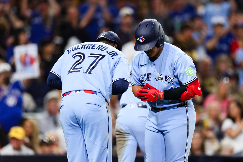 Toronto Blue Jays' Kazuma Okamoto, right, and Vladimir Guerrero Jr. celebrate after he hit a three-run home run against the San Diego Padres in the fifth inning of a baseball game Friday, July 10, 2026, in San Diego. (AP Photo/Derrick Tuskan)