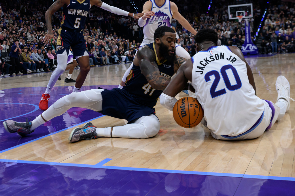 New Orleans Pelicans guard Saddiq Bey (41) and Utah Jazz forward Jaren Jackson Jr. (20) fight for possession of the loose ball during the final minute of play during an NBA basketball game, Friday, Oct. 23, 2026, in Salt Lake City. (AP Photo/Tyler Tate)