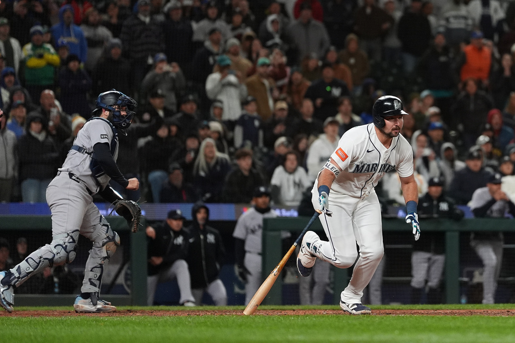 Seattle Mariners' Cal Raleigh hits a game-winning single during the ninth inning of a baseball game against the New York Yankees, Monday, March 30, 2026, in Seattle. (AP Photo/Lindsey Wasson)