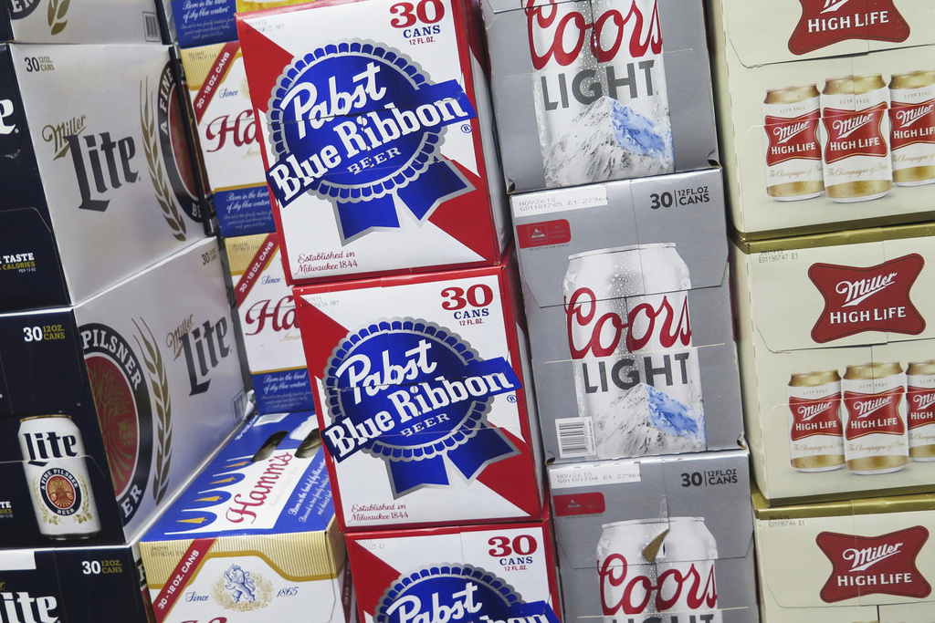 FILE - Cases of beer are stacked in a Milwaukee liquor store on Nov. 8, 2018. (AP Photo/Ivan Moreno, File)