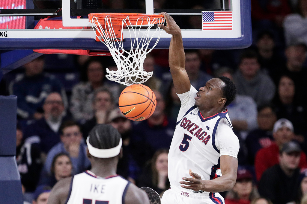 Gonzaga forward Emmanuel Innocenti (5) dunks during the second half of an NCAA college basketball game against Santa Clara, Thursday, Jan. 8, 2026, in Spokane, Wash. (AP Photo/Young Kwak)