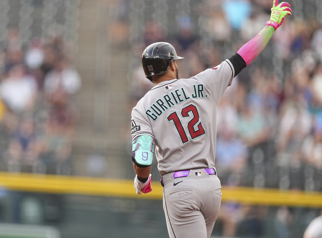 Arizona Diamondbacks' Lourdes Gurriel Jr. gestures to the bullpen as he circles the bases after hitting a three-run home run off Colorado Rockies starting pitcher Bradley Blalock in the first inning of a baseball game Thursday, Aug. 14, 2025, in Denver. (AP Photo/David Zalubowski)