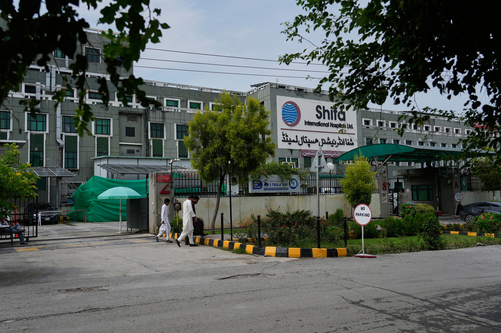 People walk past Shifa International Hospital, where imprisoned former Prime Minister Imran Khan will be transferred for a medical examination following Pakistan's Supreme Court order, in Islamabad, Pakistan, Tuesday, Aug. 18, 2026. (AP Photo/Anjum Naveed)