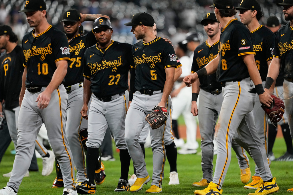 Pittsburgh Pirates second baseman Brandon Lowe (5) talks with third base coach Tony Beasley (27) as they walk back to the dugout after benches clear and the seventh inning of a baseball game against the Chicago White Sox in Chicago, Wednesday, Sept. 9, 2026. (AP Photo/Nam Y. Huh)