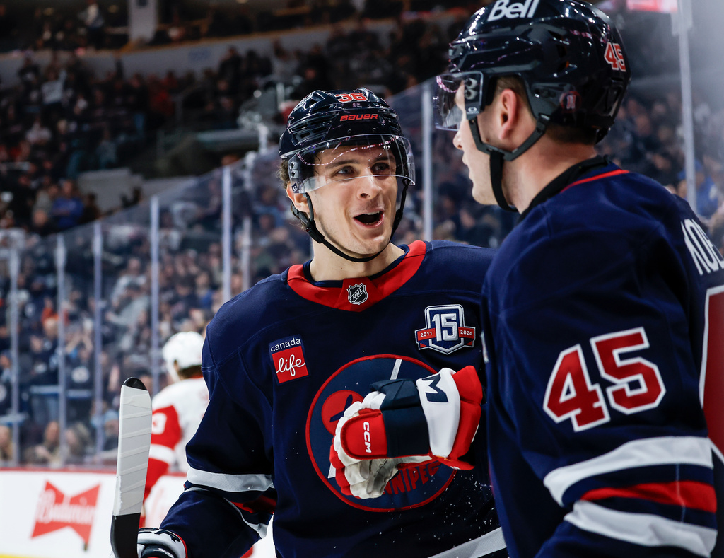 Winnipeg Jets' Morgan Barron (36) and Cole Koepke (45) celebrate Koepke's goal against the Detroit Red Wings during the second period of an NHL game in Winnipeg, Saturday, Jan. 24, 2026. (John Woods/The Canadian Press via AP)
