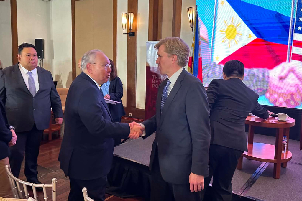United States Undersecretary of Defense for Policy Elbridge Colby, right, shakes hands with Philippine Ambassador to the U.S., Jose Manuel Romualdez during a forum in Manila, Philippines on Monday, Aug. 10, 2026. (AP Photo/Joeal Calupitan)