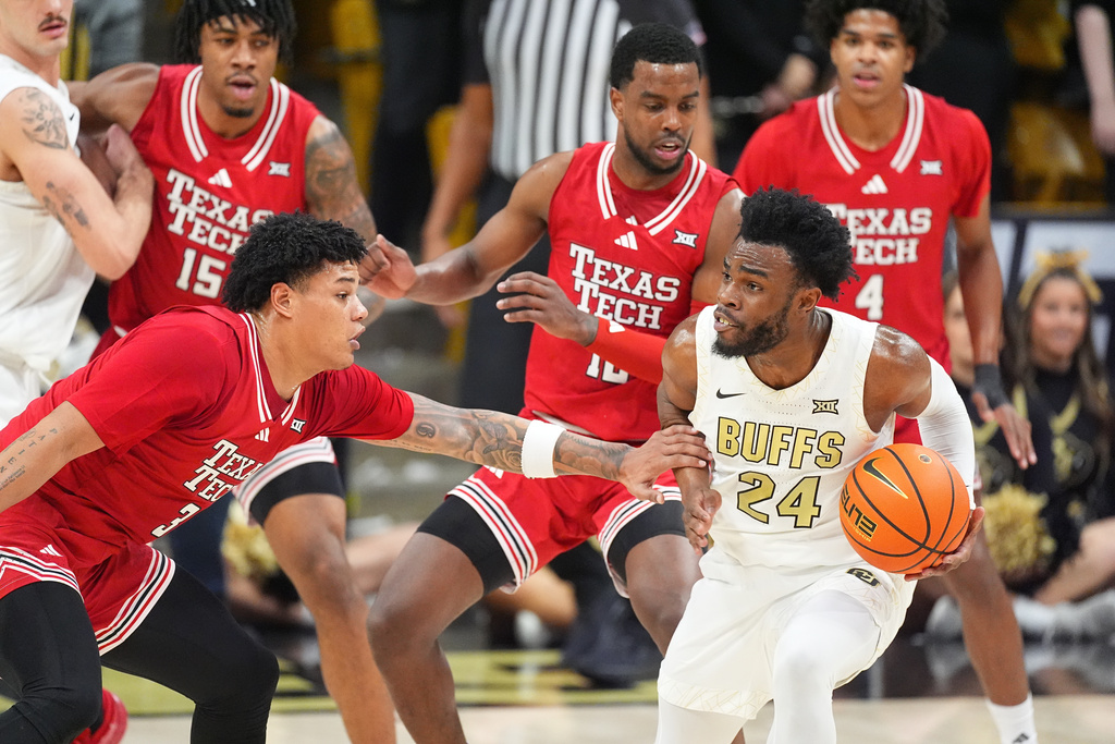 Colorado guard Barrington Hargress, right, struggles to move the ball as Texas Tech forward Lejuan Watts, left, and forward Donovan Atwell defend in the first half of an NCAA college basketball game, Saturday, Jan. 10, 2026, in Boulder, Colo. (AP Photo/David Zalubowski)