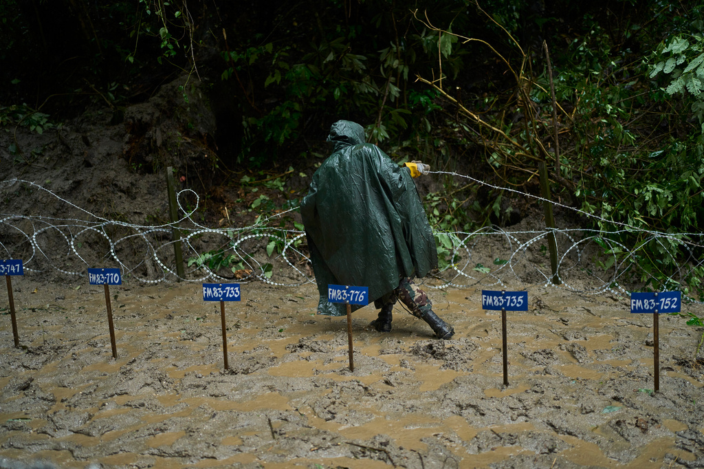 A Nepalese Army soldier prepares for the mass burial of flash flood victims in Kathmandu, Nepal, Tuesday, Sept. 1, 2026. (AP Photo/Niranjan Shrestha)