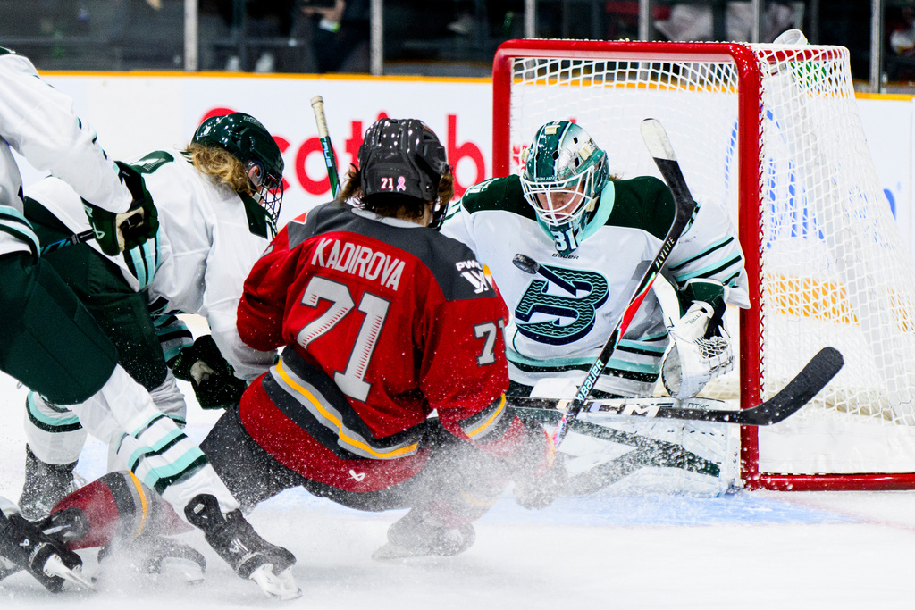 Ottawa Charge's Fanuza Kadirova (71) scores on Boston Fleet goaltender Aerin Frankel (31) during the third period of an PWHL hockey game in Ottawa, Saturday, Dec. 27, 2025. (Spencer Colby/The Canadian Press via AP)