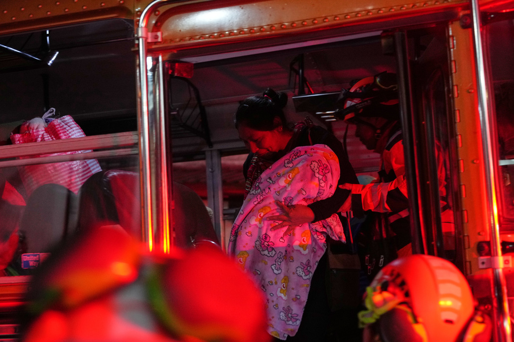Families evacuated from areas surrounding the Fuego Volcano arrive to a temporary shelter in San Juan Alotenango, Guatemala, Tuesday, Aug. 4, 2026. (AP Photo/Moises Castillo)