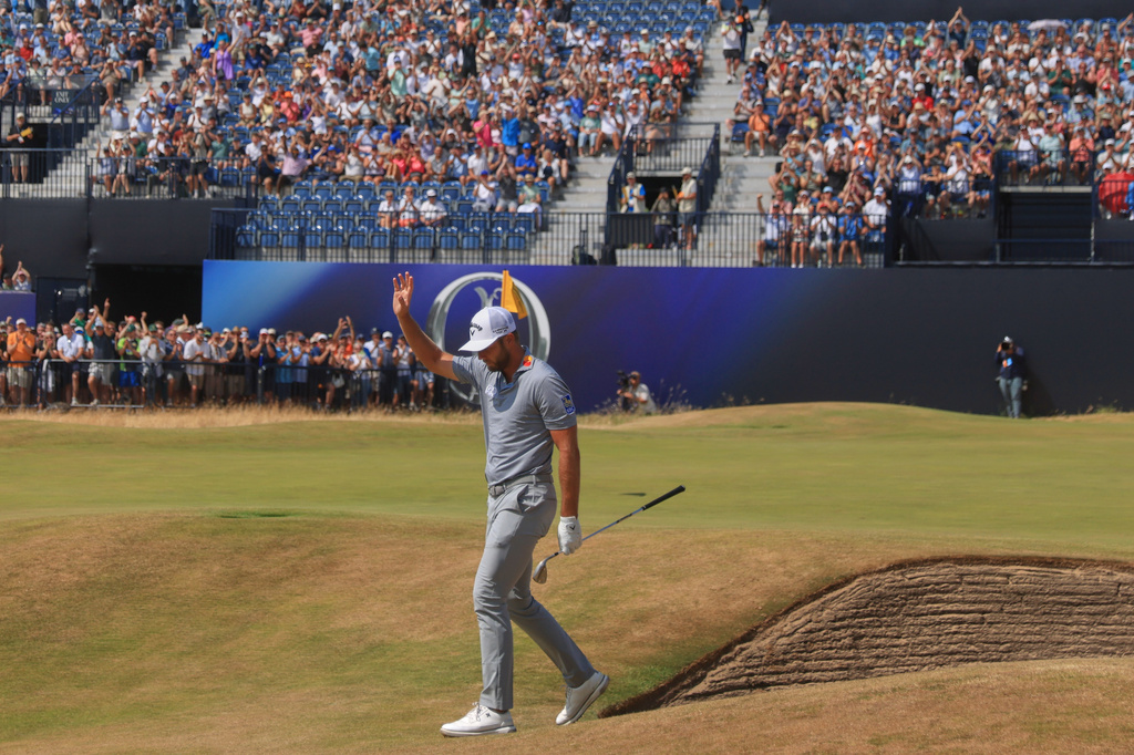 Sam Burns of the United States acknowledges the crowd after holding out from a bunker on the 18th green during the second day of the British Open Golf championships at Royal Birkdale golf club, in Southport, England, Friday, July 17, 2026. (AP Photo/Peter Morrison)